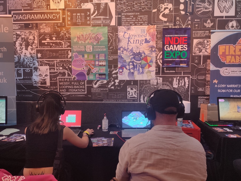 Nildigo on the left being played by an Impact! attendee, next to Clowned King by Moonana Games on the right.